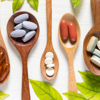 Vitamins on wooden spoons