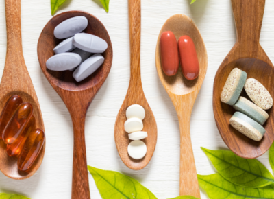 Vitamins on wooden spoons