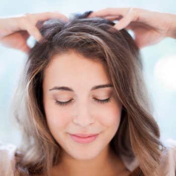Woman massaging her own scalp with fingertips